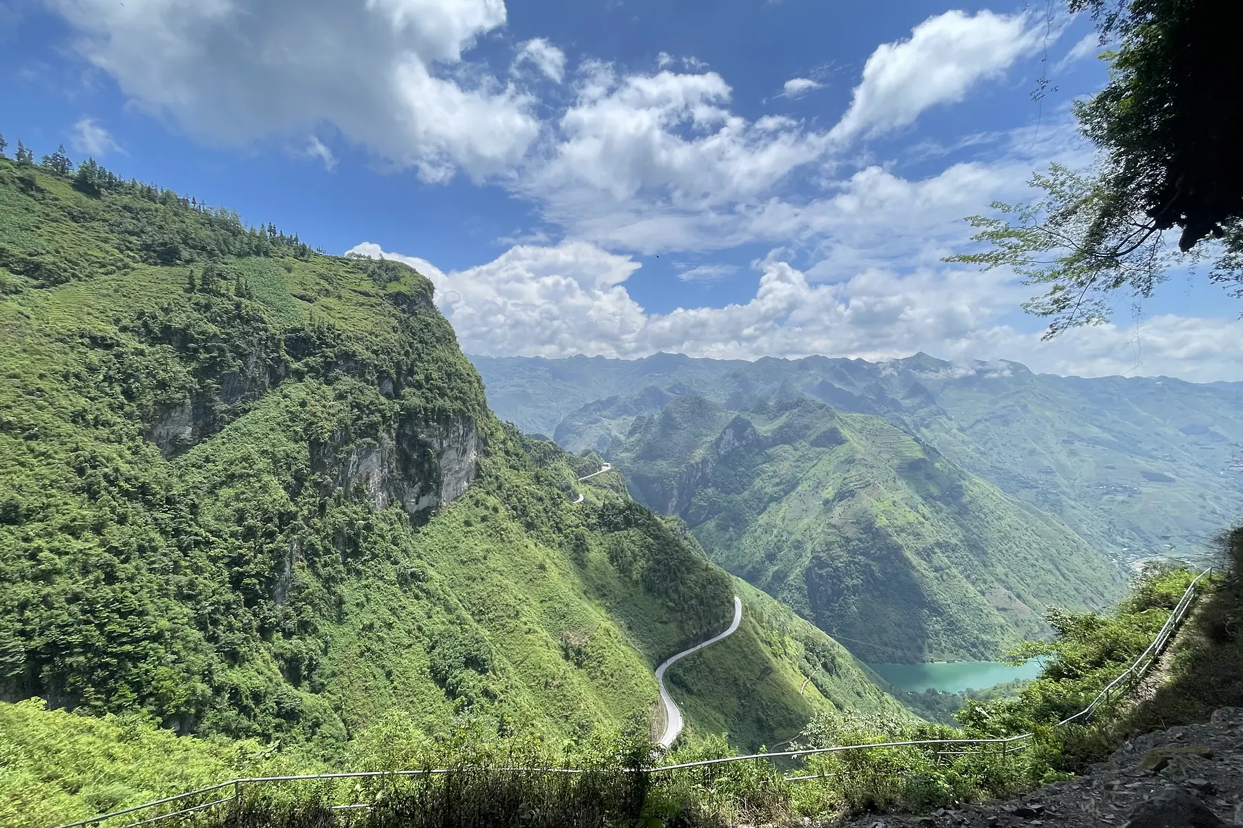A green mountain road winding through Ha Giang in summer