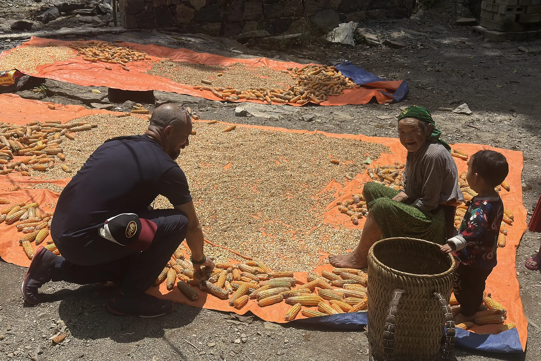 Traveller speaking with a local family during a Ha Giang village experience