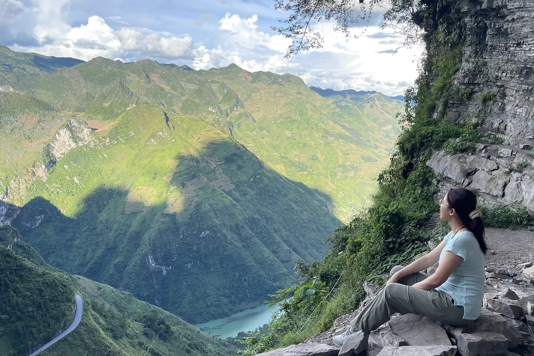 Traveller resting at a viewpoint on a Ha Giang mountain pass
